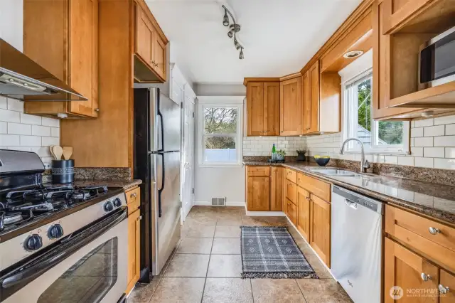Very functional kitchen that leads to the backyard. Keep an eye on everyone enjoying the outdoor space while you cook!