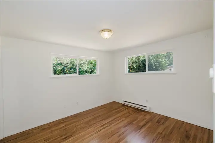 There are two possibilities for the primary bedroom.  Both have their own private bathrooms.  This one on the main floor is in the NW corner of the house with it's own bath.