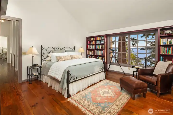 Second Primary Bedroom with expansive views and wood wrapped windows flanked by built in book shelves.