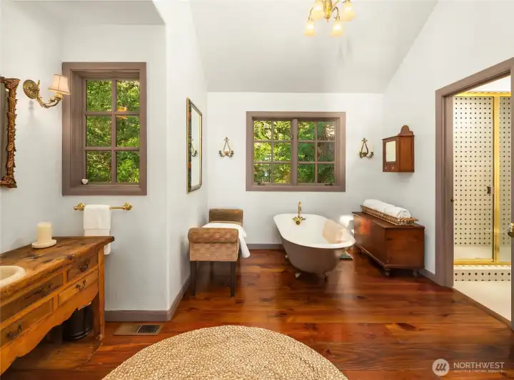 Custom vanity and claw foot tub in second primary Ensuite bathroom.
