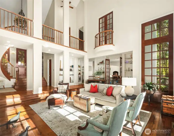 Juliet balcony from Second primary bedroom opens to grand living room with open upper walkway.