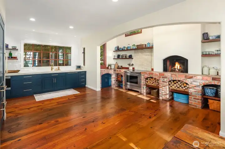 Open kitchen with built in arched fireplace preserving the homes original mission inspired cooking area includes aged brick base with built in arches.  Premium real stone Quartzite, Taj Mahal leathered finish.