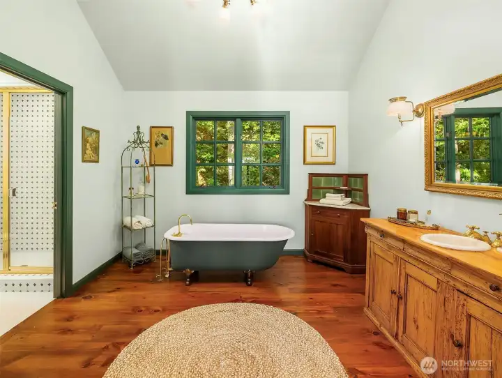 Primary Ensuite bathroom with claw foot tub, custom vanity and walk in shower.