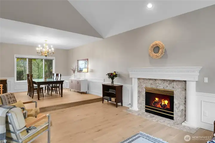 Formal living room with vaulted ceiling, LVP flooring and gas fireplace