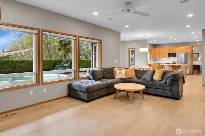Family room with custom gas fireplace, wood built ins, and LVP flooring