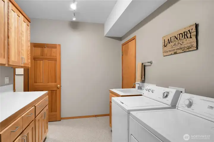 Laundry room on main floor with attached 3/4 bath with outside access