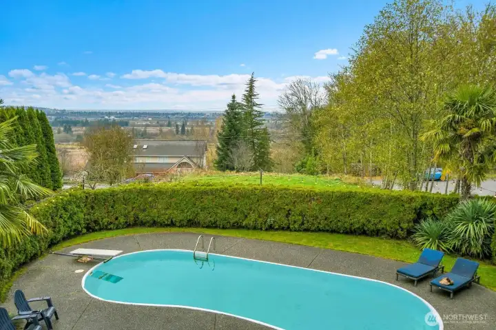 In ground pool in private backyard with slough views