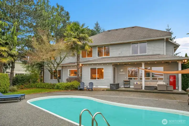 In ground pool in private backyard with covered patio