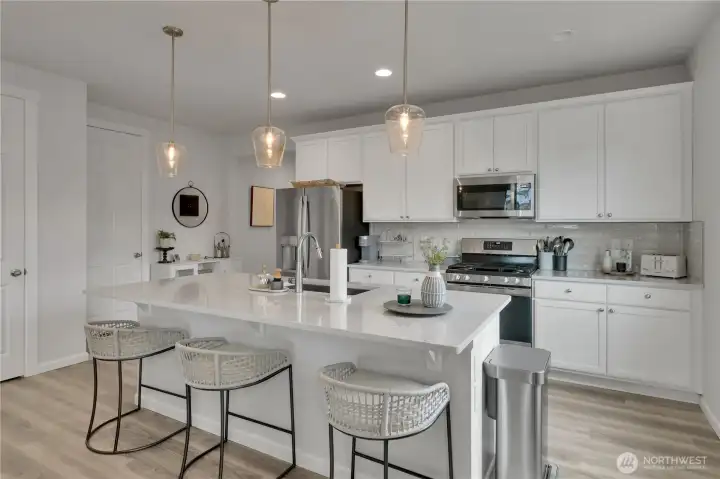 Kitchen island with pendant lights, pantry to the far left ~