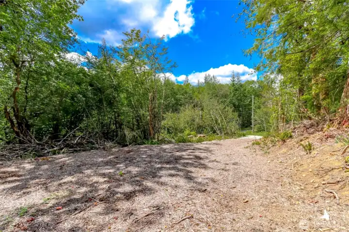 Flat part of lot near top of entrance/unpaved driveway.