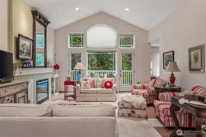 Bright and spacious living area with vaulted ceilings and rich hardwood floors.