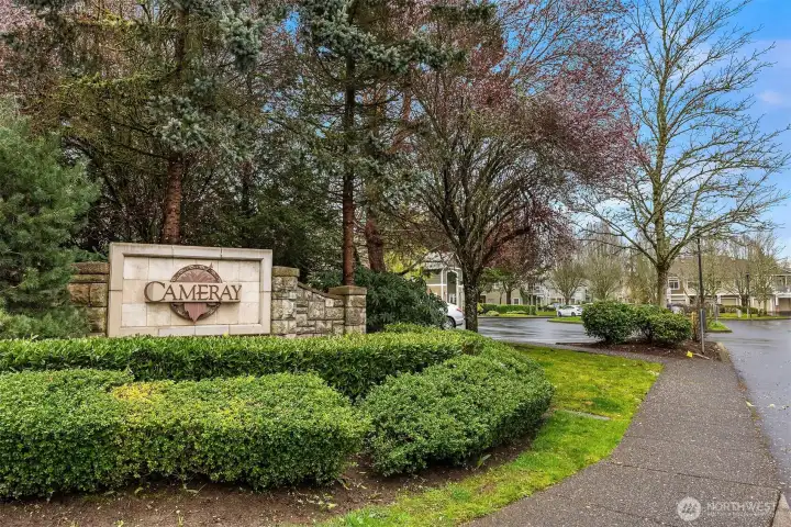 The welcoming entrance to the Cameray community sets the tone with mature, manicured landscaping and classic signage, a beautifully maintained neighborhood that reflects the pride of ownership throughout.