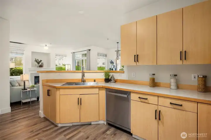 A closer look at the kitchen highlights the ample cabinetry, generous counter space, and quality appliances, all bathed in natural light from the surrounding windows for a bright and efficient workspace.
