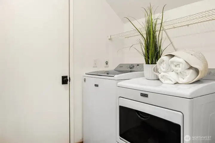 The in-unit laundry area features a full-size side-by-side washer and dryer, a highly convenient amenity that adds everyday ease and practicality to this thoughtfully designed home.