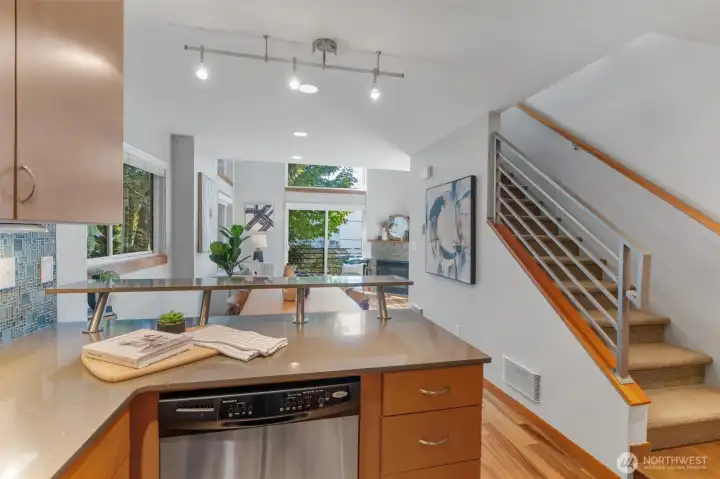 Enjoy a stylish kitchen with stone slab countertops, designer tile and gas range.