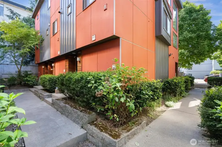 Interior courtyard provides a private entrance for the unit (left side, near the tree).
