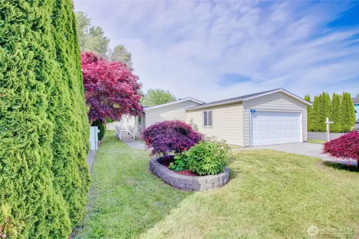 Pretty front yard area leading you to the front door. 2 car garage attached. Pretty front yard area leading you to the front door. 2 car garage attached.