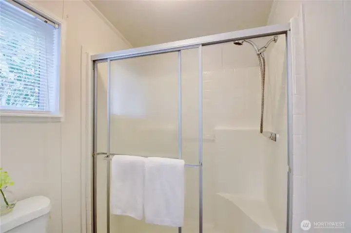 Walk-in shower and toilet located within primary bath. Walk-in shower and toilet located within primary bath.