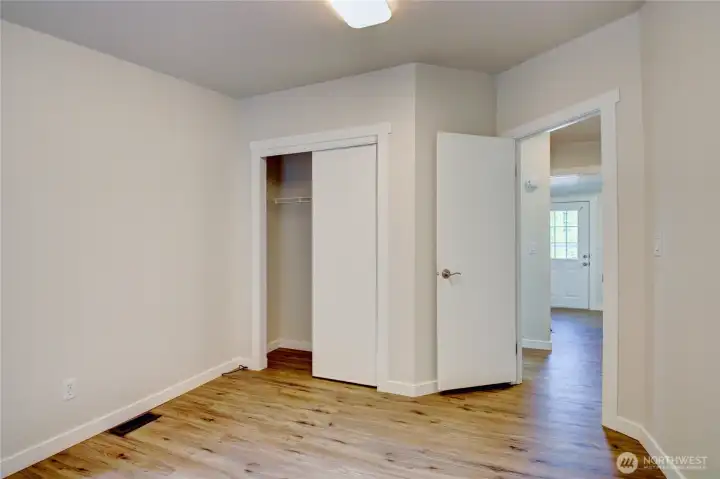 Second bedroom looking toward hall and laundry room door. Second bedroom looking toward hall and laundry room door.
