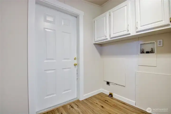 Laundry room with extra storage and access to two car garage. Laundry room with extra storage and access to two car garage.