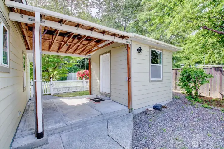Covered patio attached to back of home with access to shed. Covered patio attached to back of home with access to shed.