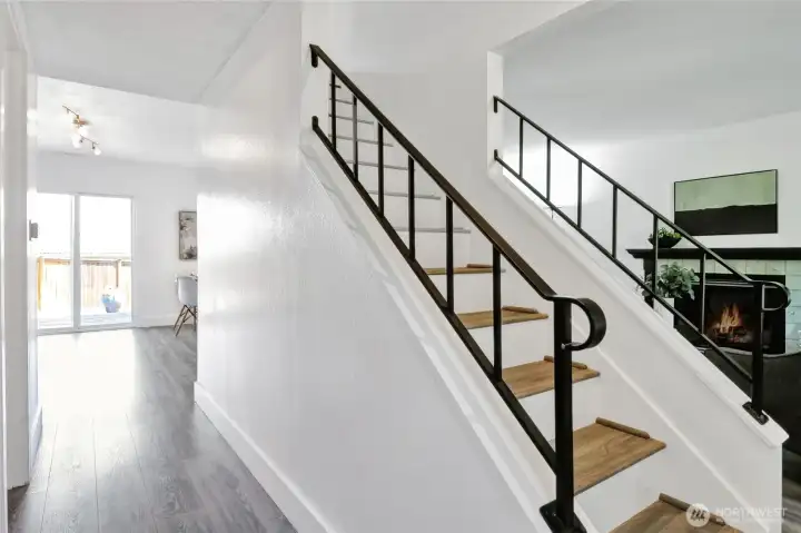 From the front door the hall on the left leads past the powder room to the dining area with the living room on the right.  Note the fresh paint throughout the entire interior and brand-new LPV flooring.  Even the stairway was redone with new treads/steps and handrail.  There is a large storage area under the stairs accessed at then end of the hall.