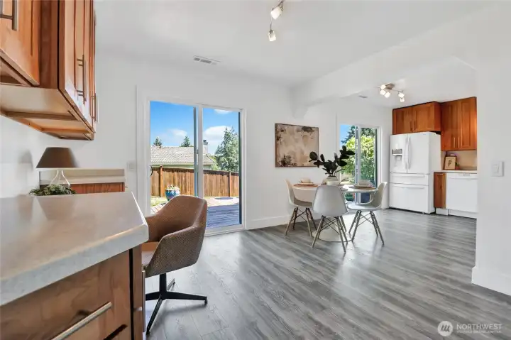 View of dining/flex area and open kitchen area.  Shows the 2 sliding doors out to the oversized deck and fantastic backyard.