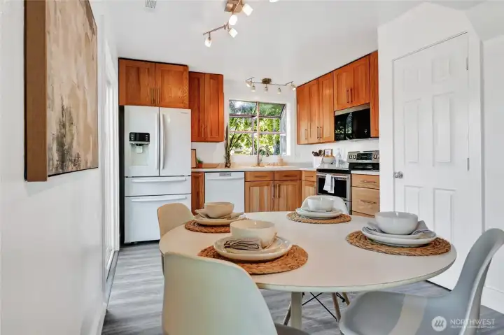 The dining area with the kitchen beyond.  The door on the right is the pantry and one of the 2 glass doors to the deck and back yard is on the left.