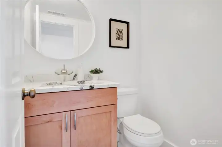Convenient powder room on the main floor.  This was remodeled with top to bottom --all new vanity, quartz countertops, faucet, flooring and toilet.
