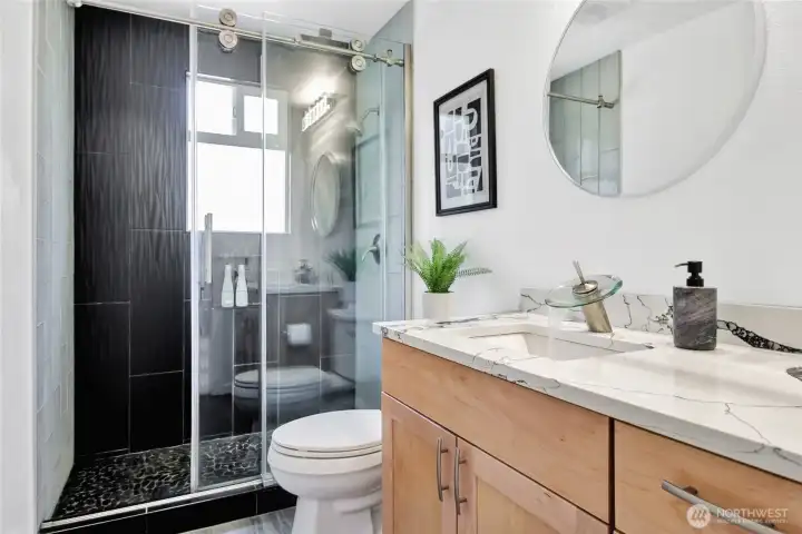 Primary suite was also completely remodeled with new tile tub surround, new flooring, quartz countertops, flooring, etc.
