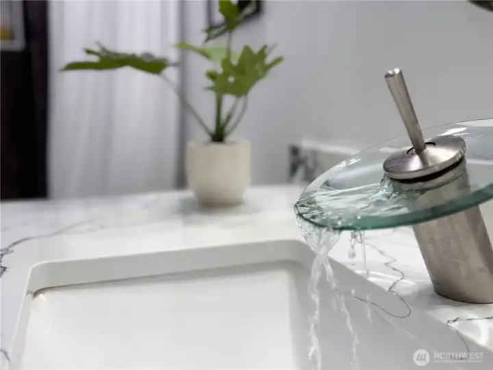 All bathrooms have unique matching designer faucets and quartz countertops