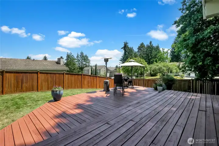 View across back yard deck towards. the southeast corner of property