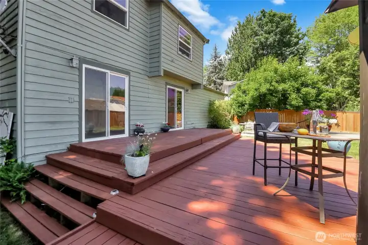 Two sliding glass doors from the kitchen and dining area open wide to the spacious deck and back yard, making iit deal for indoor/outdoor living. Imagine as large summer gathering with friends and family flowing freely in and BBQ grilling, food buffet set up on the deskside countertops, kids & pets playing safely in fully ar fenced yard. Separate areas for comfortable conversations. This photo shows only a portion of the deck.