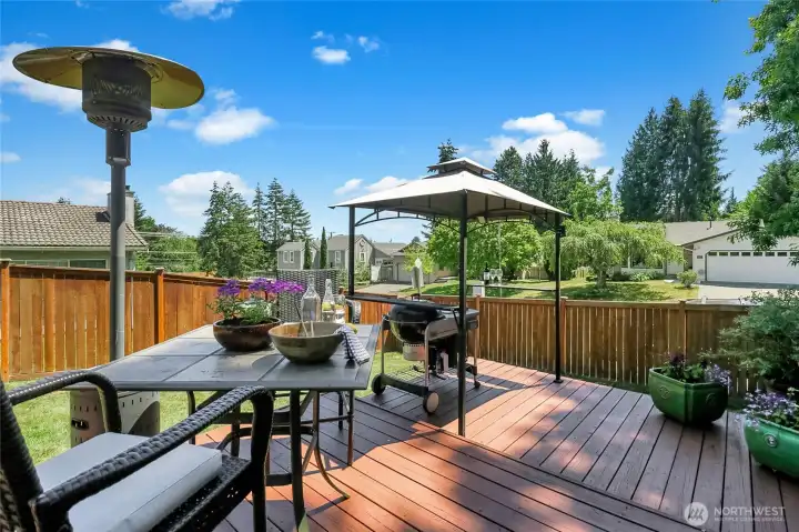The backyard deck is enormous! The covered gazebo structure provides the perfect spot for your BBQ