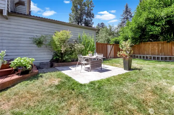 This concrete patio is steps off the wood deck and offers additional entertaining space. It could also be the perfect location of a future hot tub. Wiring from a former hot tub remains in place.