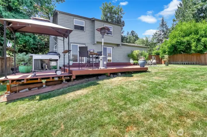 View from back fence towards the deck and back of home.  So much space!  The gazebo structure show on the left will remain with the property.