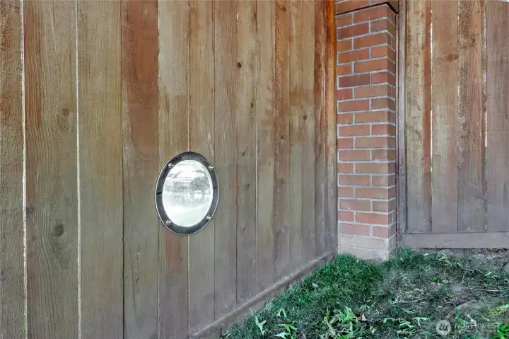 The back yard is fully fenced with a 6' cedar privacy fence, but there is a 'doggy portal'for oru furry friends to have an "outside the fence view"