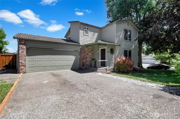 Plenty of parking on site with the 2-car garage plus 2 driveway parking spots in front.  Additionally, there is a graveled RV parking area (left of photo) that can fit up to a 44' trailer. There is also a 50amp charger for an RV.