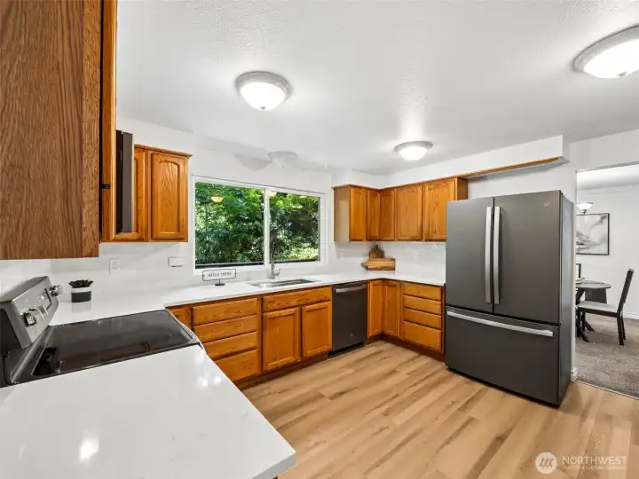 Spacous kitchen with new quartz countertops, tile backsplash, new sink and paint. Fingerprint free stainless appliances all stay!