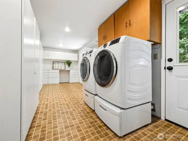 Part one of super-sized laundry room. Newer washer and dryer stay for the buyers.