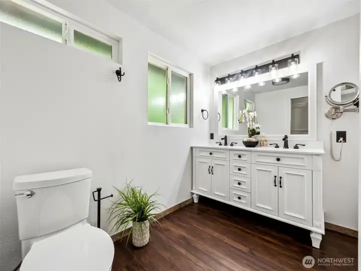Other side of the primary bath showing the tub/shower combination.  To the left of this photo is the Walk-in-Closet with custom built-ins.