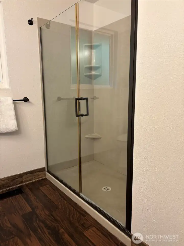 Large walk-in-shower across from the vanity in the hall bath.