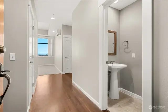 Entry way with powder room on the right, living space straight ahead and bedrooms and main bath to the right.