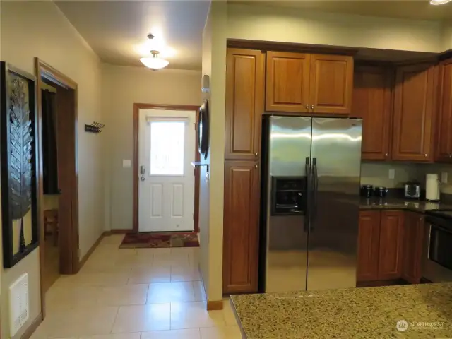 Perspective of kitchen and the front entry.