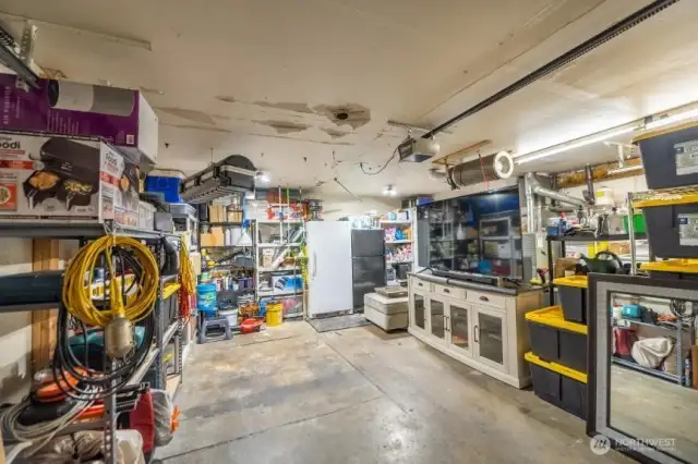 Owner parks her car in the garage at night. Extra items in the space due to packing.