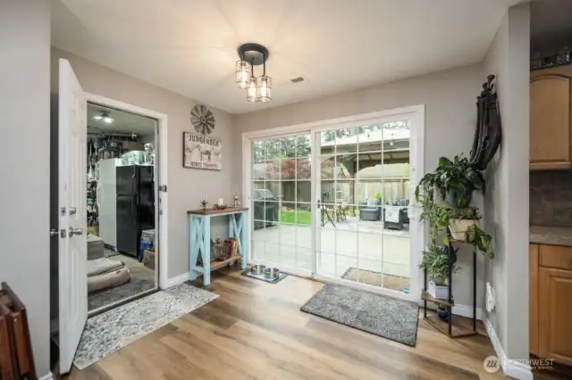 spacious dinner room with access to the double car garage.  Over sized slider allows for tranquil views and floods the home with light year round.