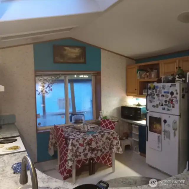 Well organized kitchen area with a view out toward the front of the home, looking toward the deck and the lake.