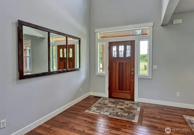 Grand entrance with hard wood and custom tile.