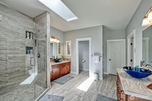 Ensuite bathroom boasts walk in shower w/ two heads, double sinks and walk in closet.