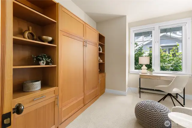 Dedicated office space with a custom-built Murphy bed, easily transforming the room into a comfortable guest bedroom when needed.
